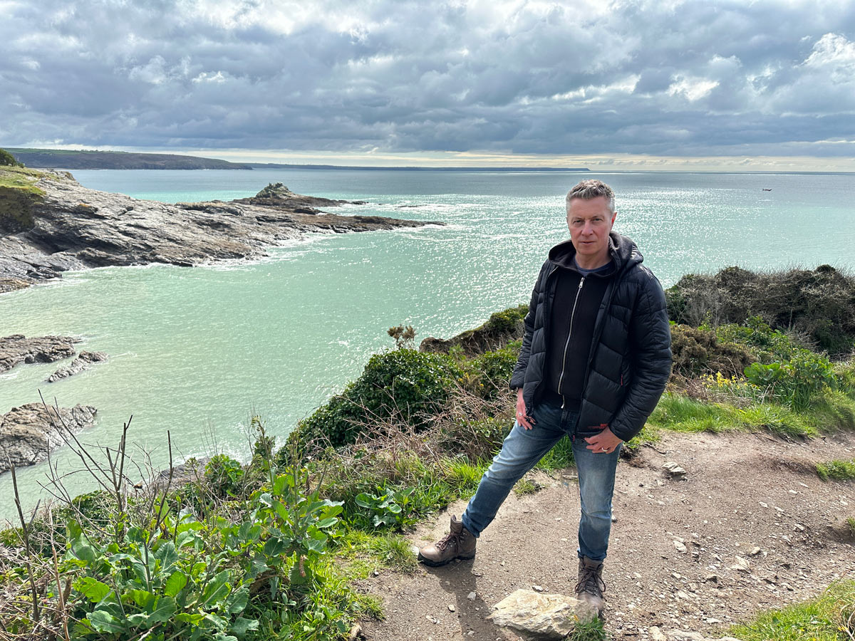 Neil Canning artist portrait on Cornish coastline